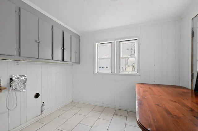 a view of a room with white cabinets