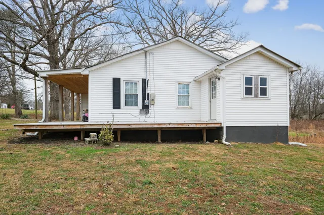 a front view of a house with a garden and deck