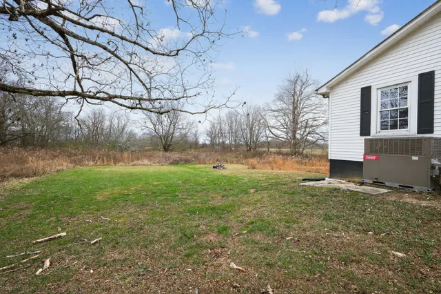 a backyard of a house with lots of green space