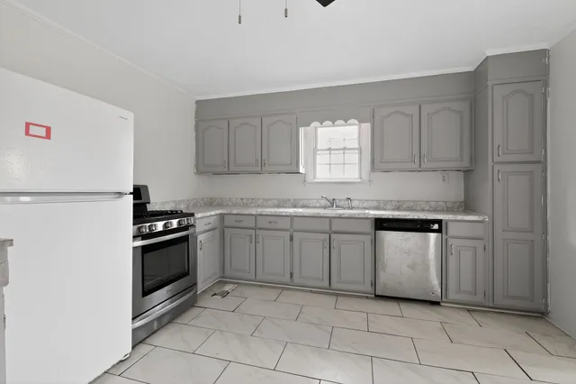 a kitchen with granite countertop cabinets and steel stainless steel appliances