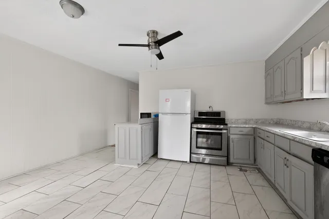 a kitchen with granite countertop a cabinets and steel appliances