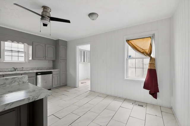 a kitchen with a stove a sink and a refrigerator
