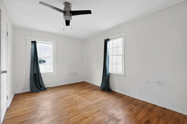 wooden floor in an empty room with a window
