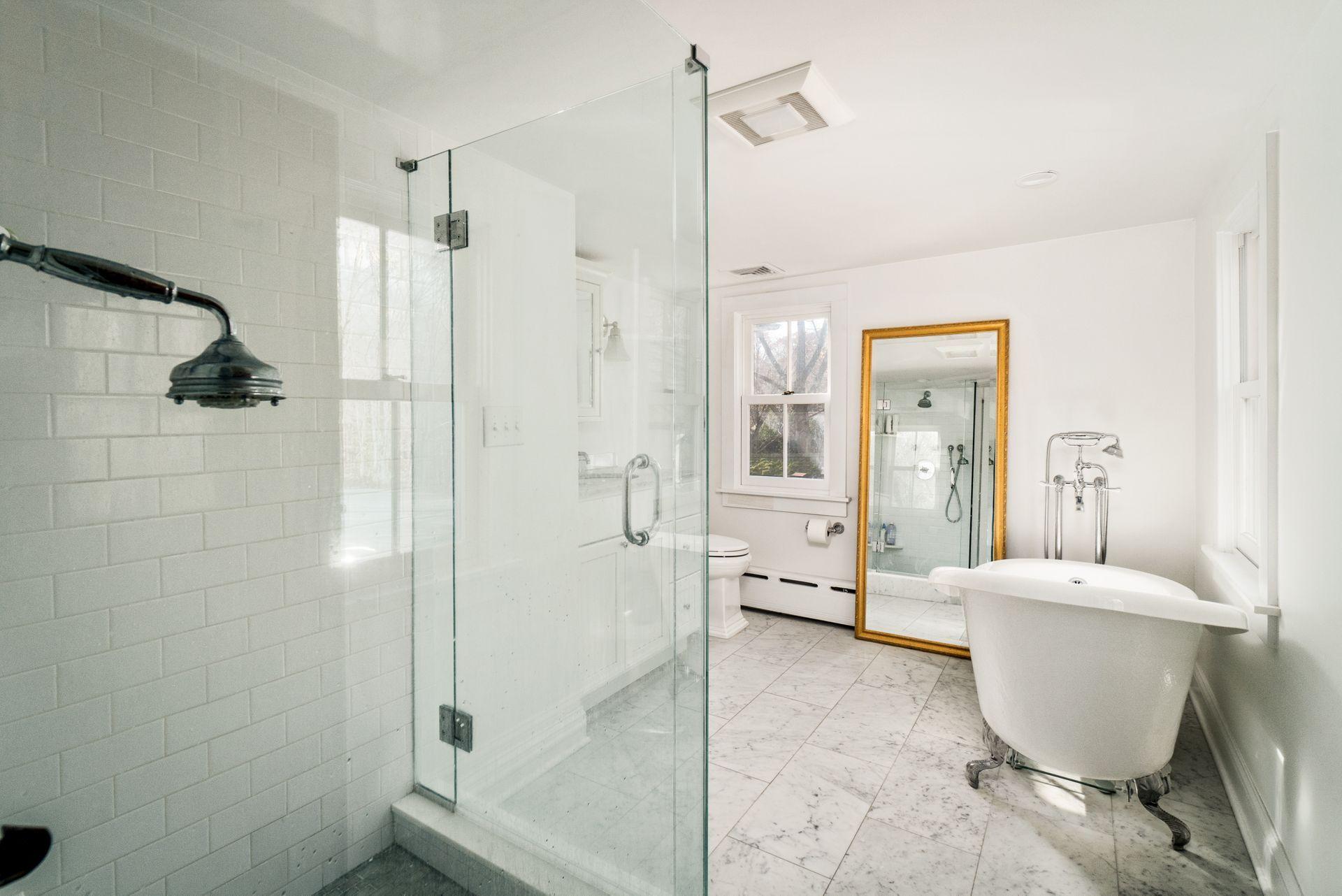1122 Smith Ridge Road New Canaan, CT 06840 - Photo 19 of 25 a spacious bathroom with a shower and a glass door
