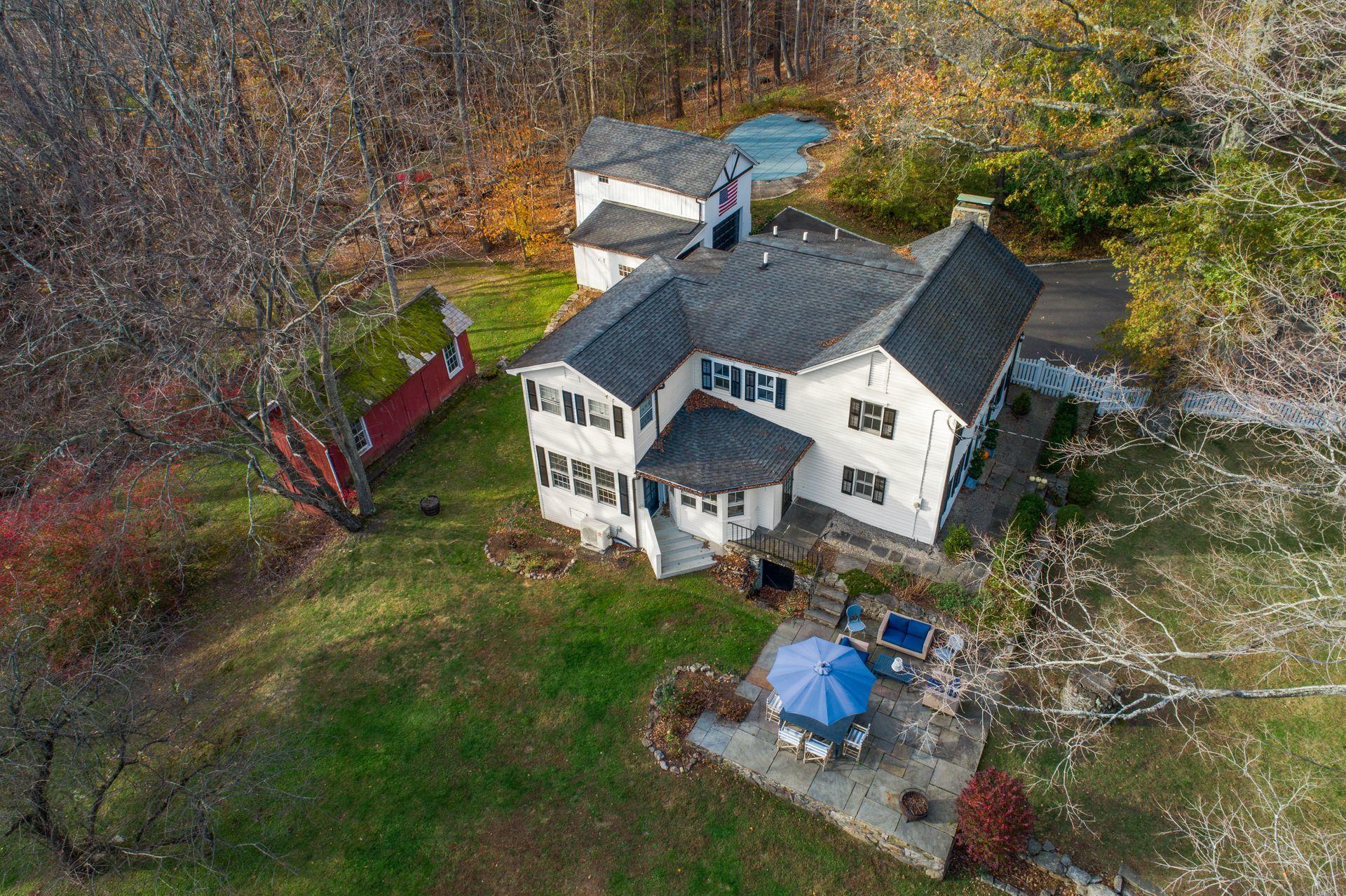1122 Smith Ridge Road New Canaan, CT 06840 - Photo 2 of 25 an aerial view of a house with outdoor space