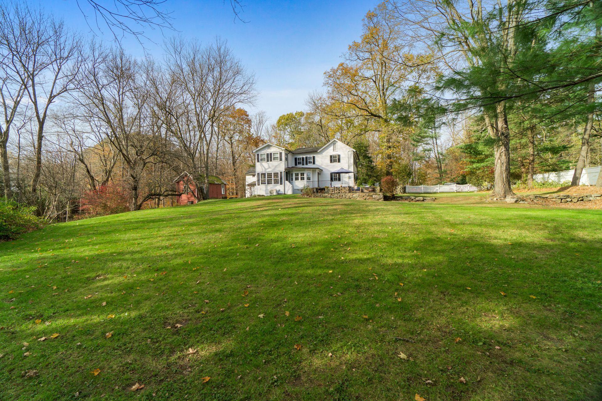 1122 Smith Ridge Road New Canaan, CT 06840 - Photo 23 of 25 a large building with trees in front of it