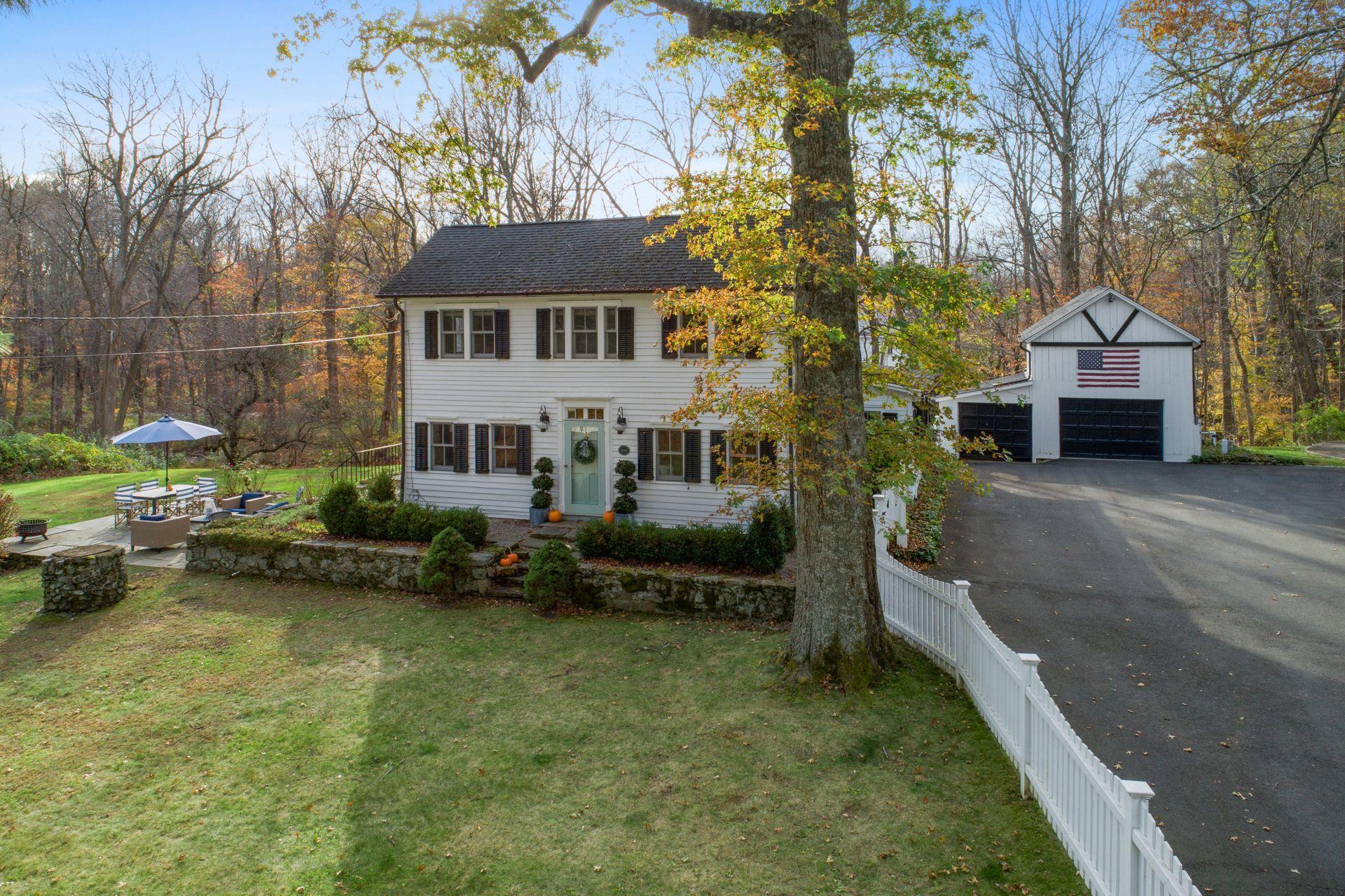 1122 Smith Ridge Road New Canaan, CT 06840 - Photo 24 of 25 a view of a house with a yard siting area and garden