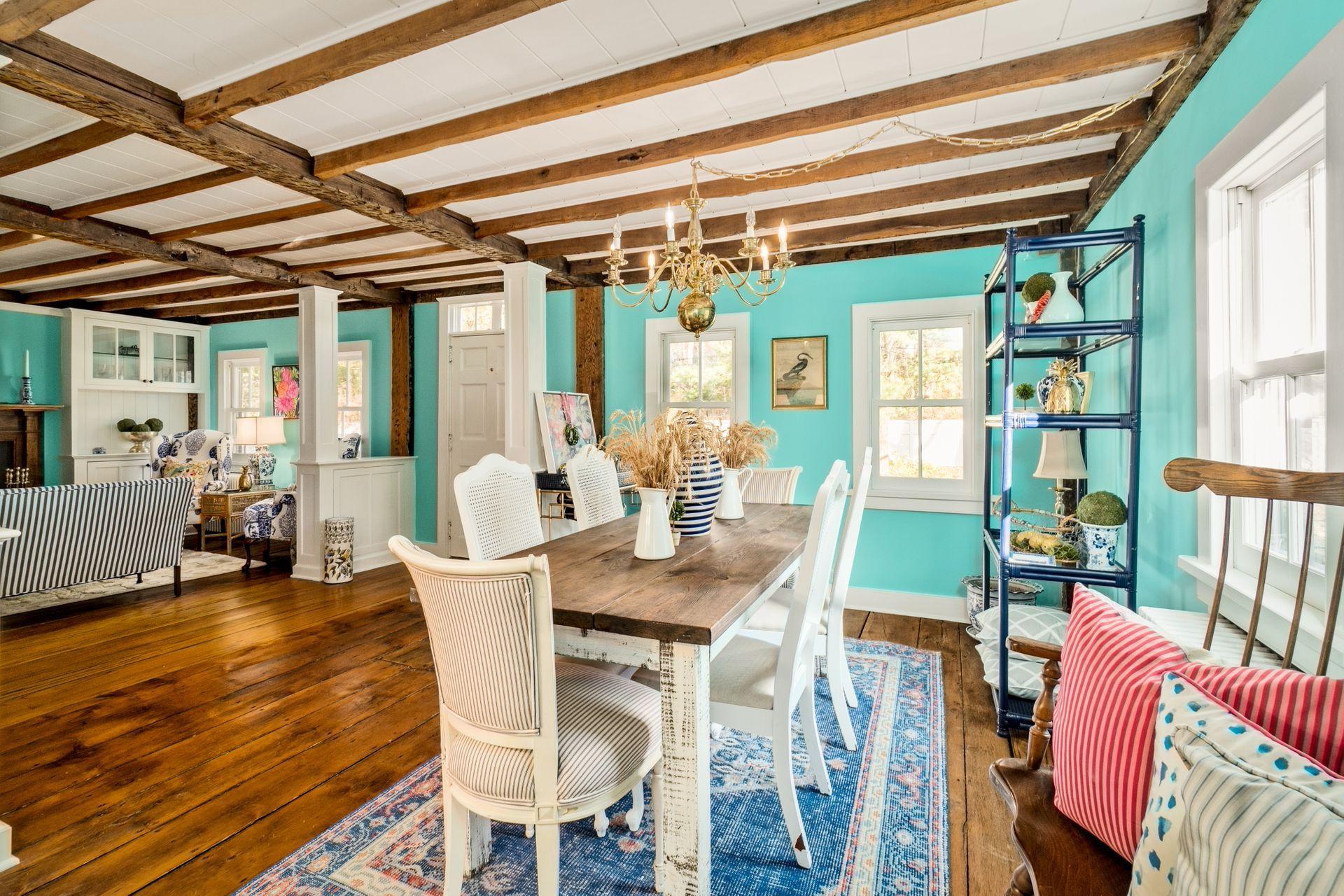 1122 Smith Ridge Road New Canaan, CT 06840 - Photo 3 of 25 a view of a dining room with furniture wooden floor and a chandelier