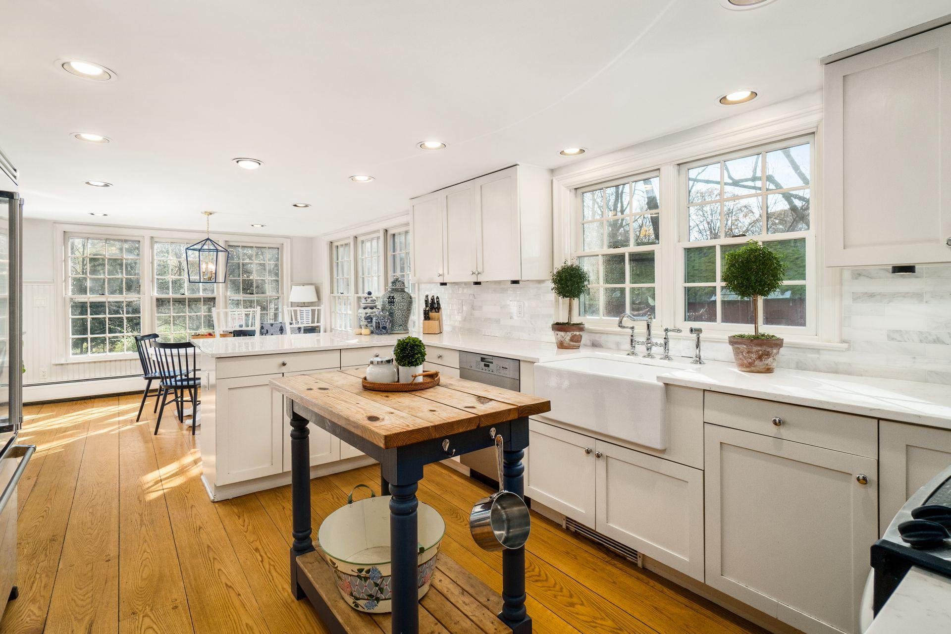 1122 Smith Ridge Road New Canaan, CT 06840 - Photo 6 of 25 a kitchen with a table chairs stove and wooden floor