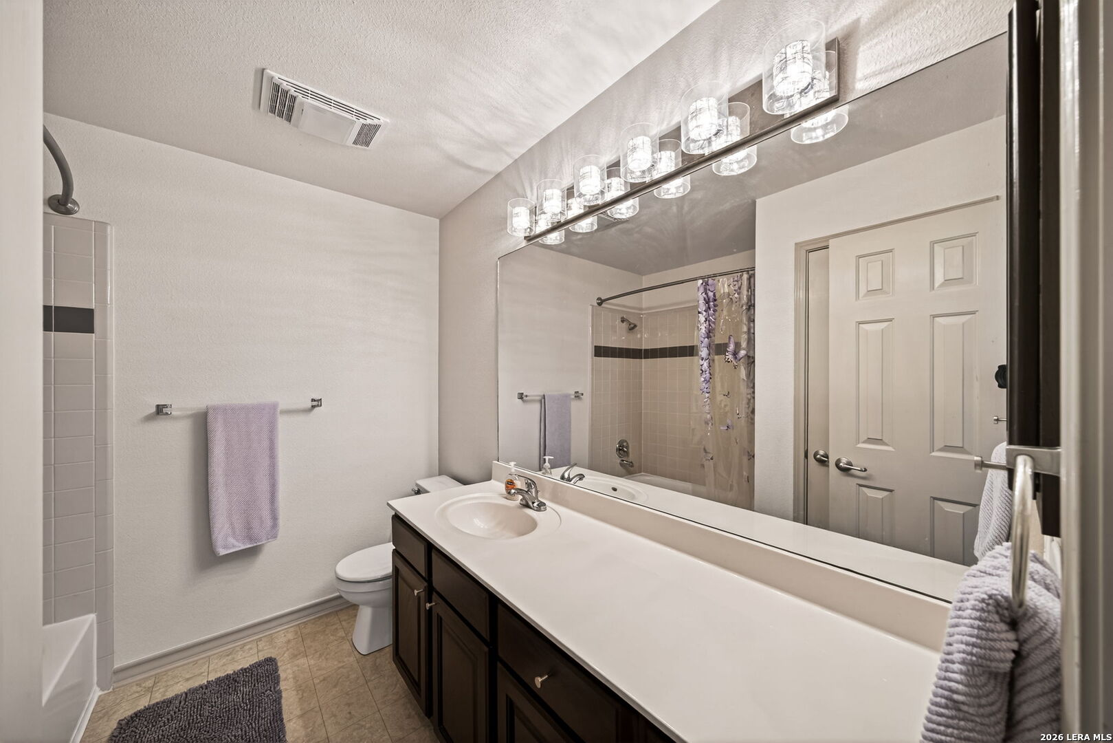 17431 Helotes Spring Road Helotes, TX 78023 - Photo 31 of 50 a bathroom with a sink a mirror and a shower