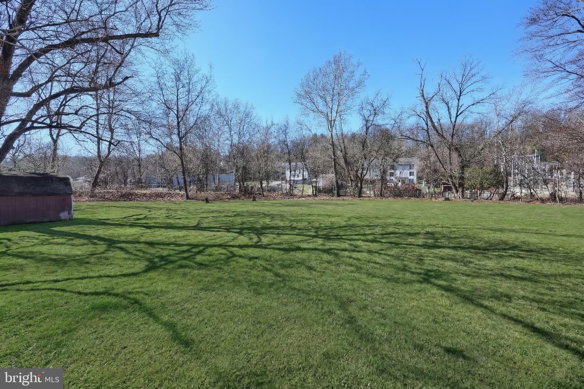 101 Tri Hill Road York, PA 17403 - Photo 7 of 34 Spacious green expanse under clear skies.