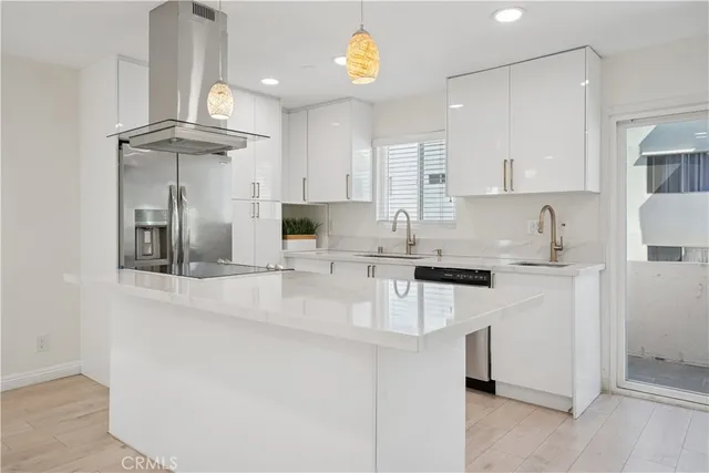 a kitchen with stainless steel appliances granite countertop a sink a stove and cabinets