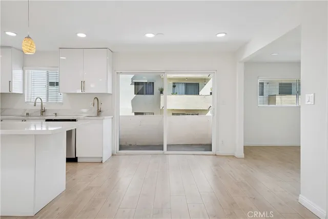 a kitchen with white cabinets and white appliances