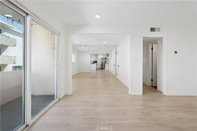 a view of a hallway with wooden shelves