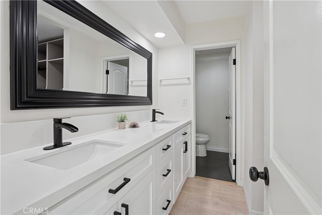 5330 Zelzah Avenue, Unit 7 Encino, CA 91316 - Photo 25 of 35 a bathroom with a double vanity sink mirror and toilet