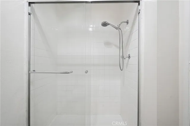 a bathroom with a glass shower door