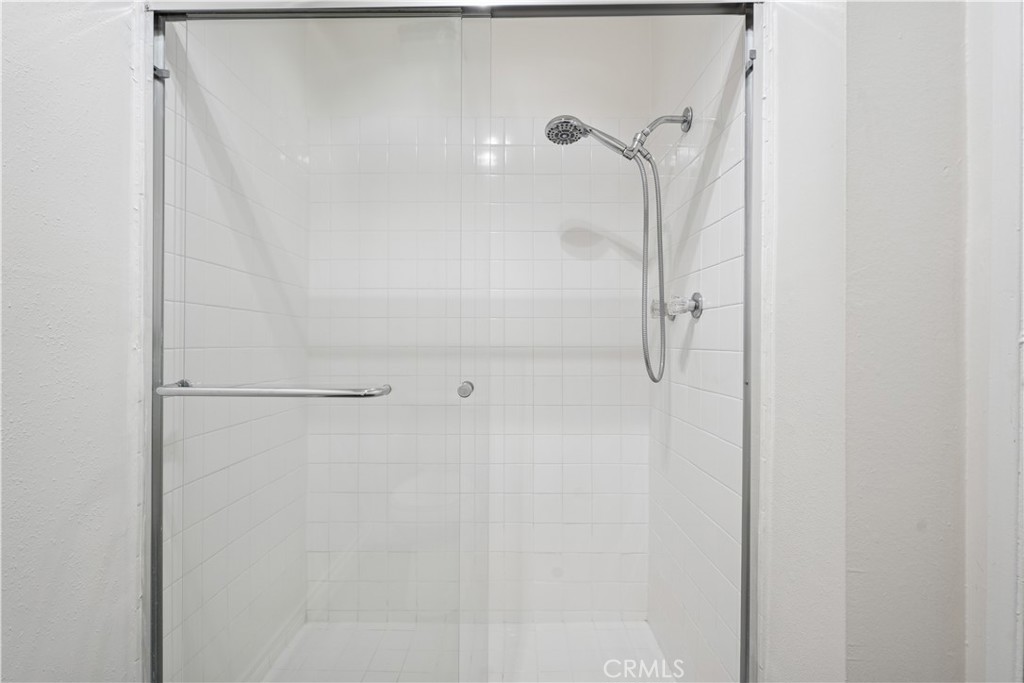 5330 Zelzah Avenue, Unit 7 Encino, CA 91316 - Photo 27 of 35 a bathroom with a glass shower door