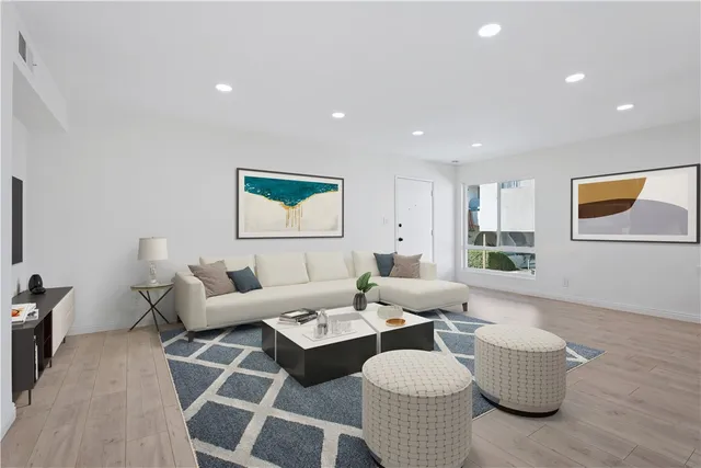 a living room with furniture and wooden floor