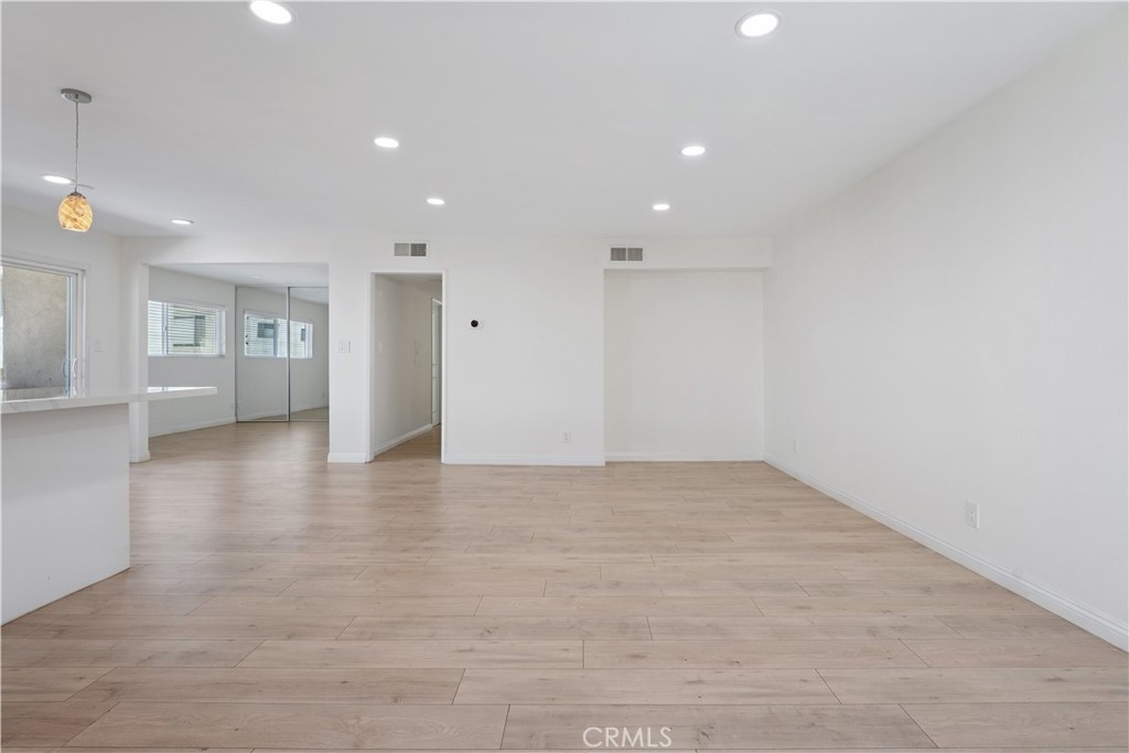 5330 Zelzah Avenue, Unit 7 Encino, CA 91316 - Photo 7 of 35 a view of an empty room with wooden floor and windows