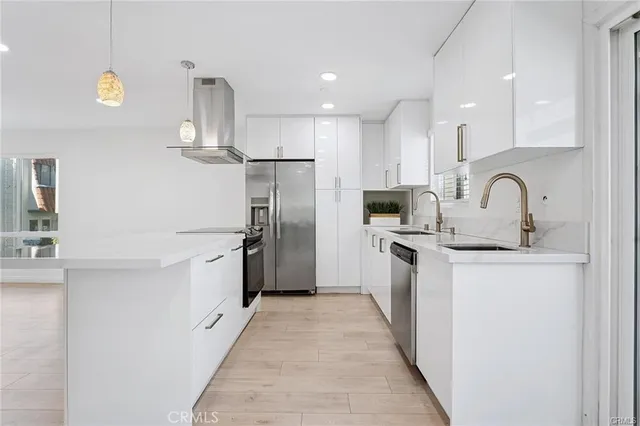 a kitchen with stainless steel appliances a refrigerator and a sink