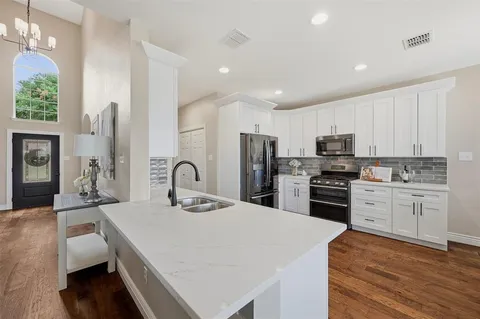 a kitchen with stainless steel appliances a refrigerator sink and stove