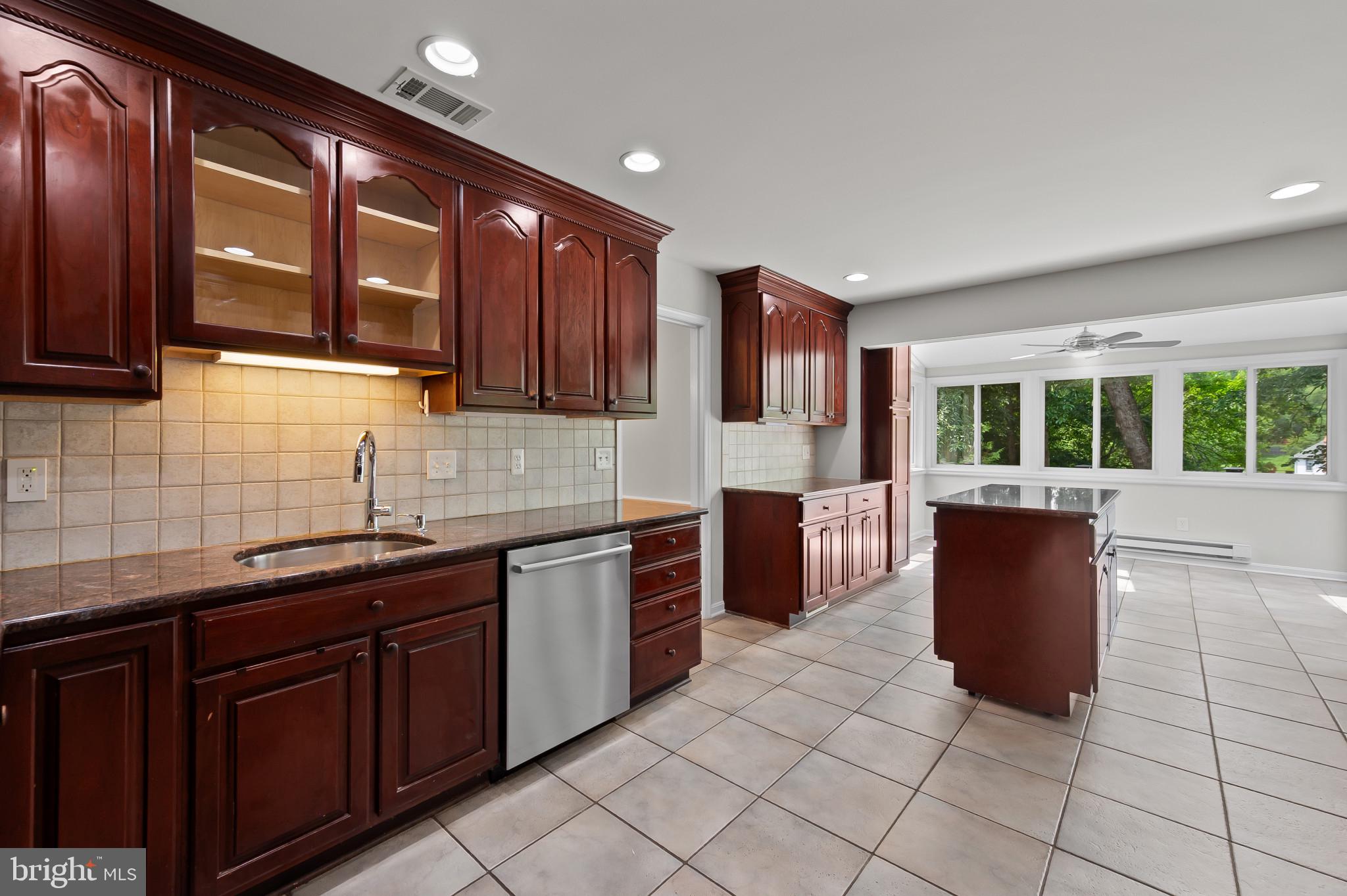 15016 Wellwood Road Silver Spring, MD 20905 - Photo 11 of 52 a kitchen with stainless steel appliances granite countertop a stove a sink and a microwave