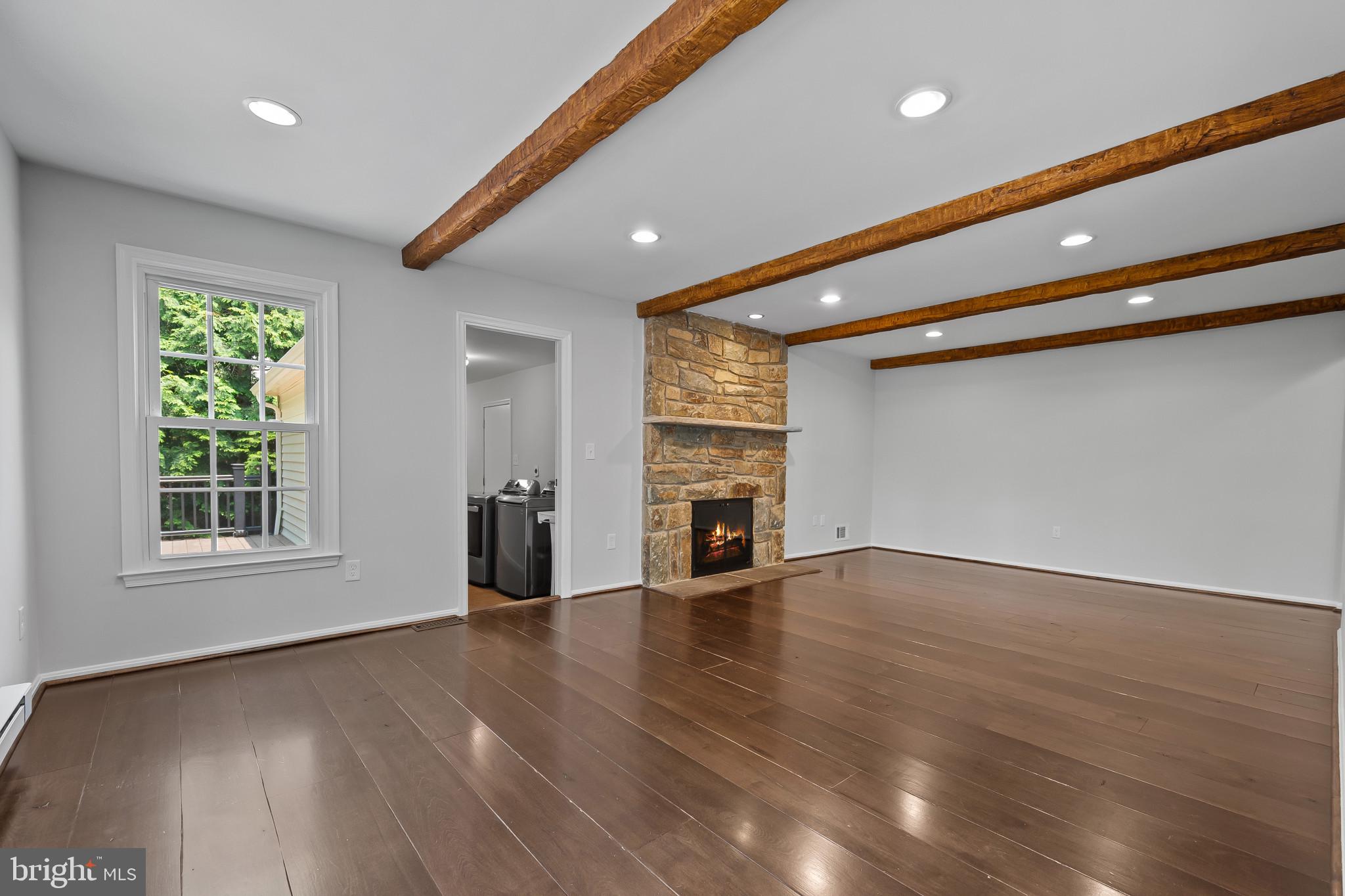 15016 Wellwood Road Silver Spring, MD 20905 - Photo 15 of 52 a view of an empty room with wooden floor and a window