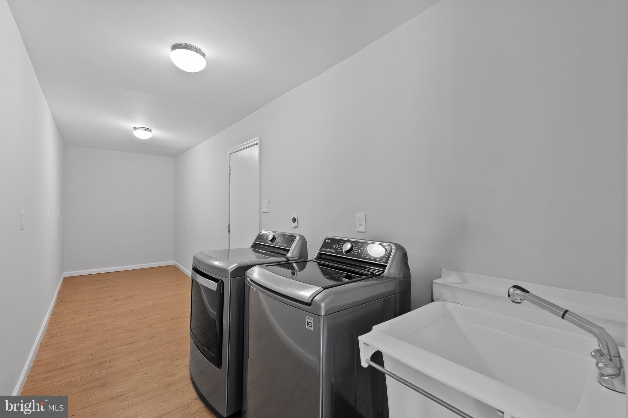 15016 Wellwood Road Silver Spring, MD 20905 - Photo 17 of 52 a utility room with dryer and washer