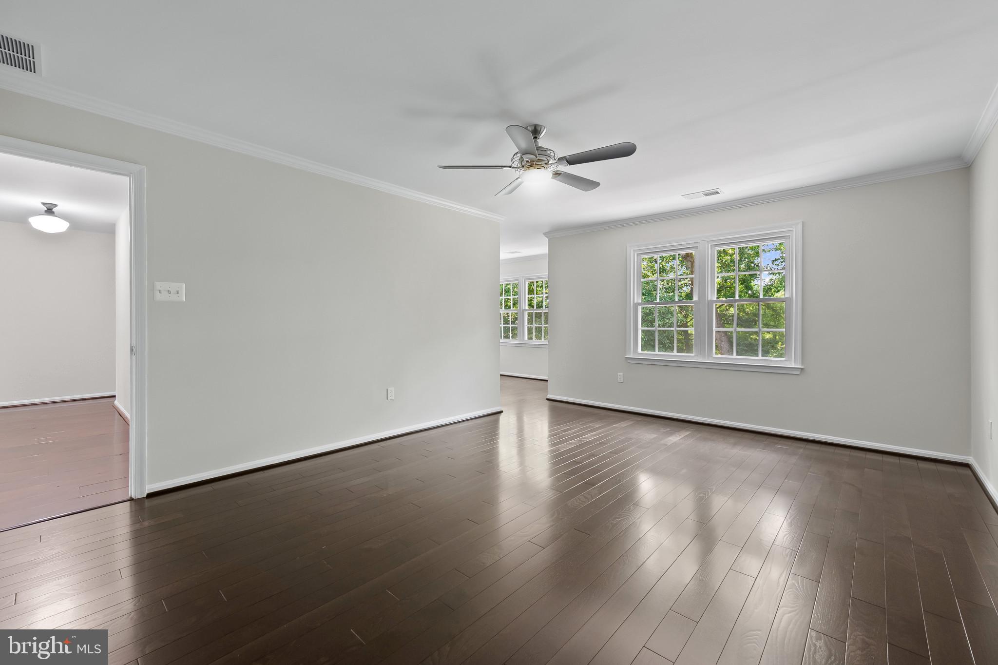 15016 Wellwood Road Silver Spring, MD 20905 - Photo 22 of 52 a view of an empty room with wooden floor and a window