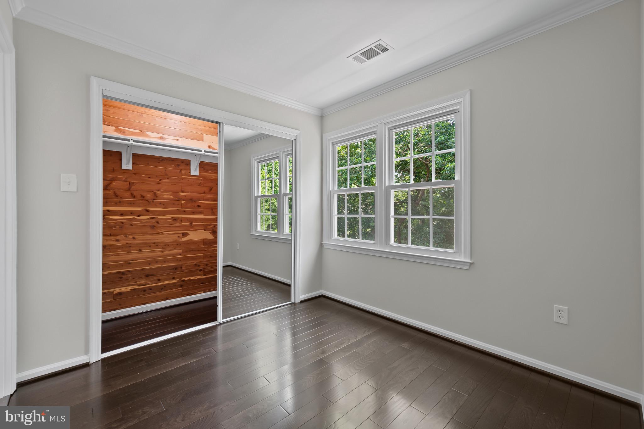 15016 Wellwood Road Silver Spring, MD 20905 - Photo 24 of 52 an empty room with wooden floor and windows