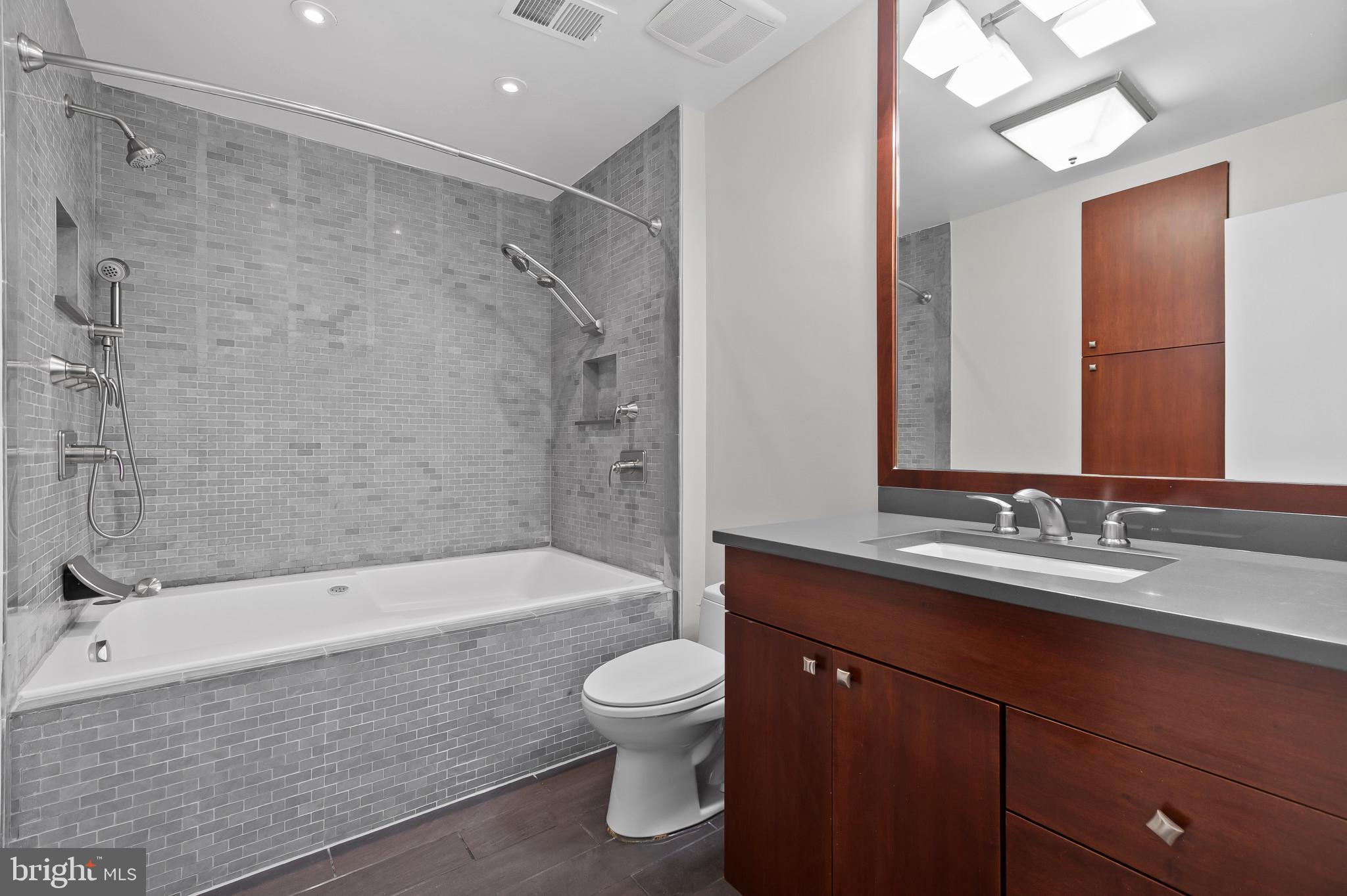 15016 Wellwood Road Silver Spring, MD 20905 - Photo 25 of 52 a bathroom with a sink a toilet and shower