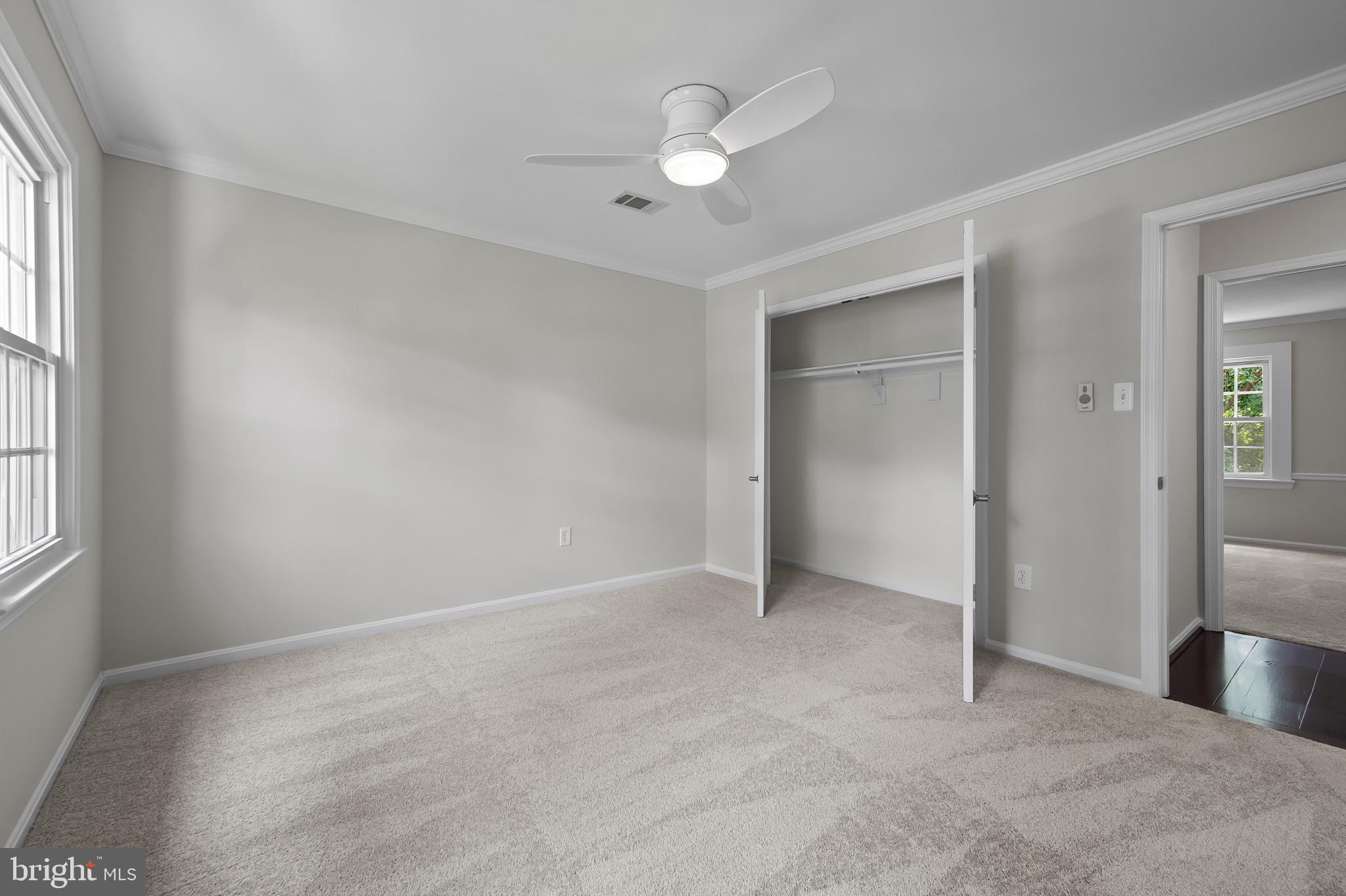 15016 Wellwood Road Silver Spring, MD 20905 - Photo 29 of 52 an empty room with closet and windows