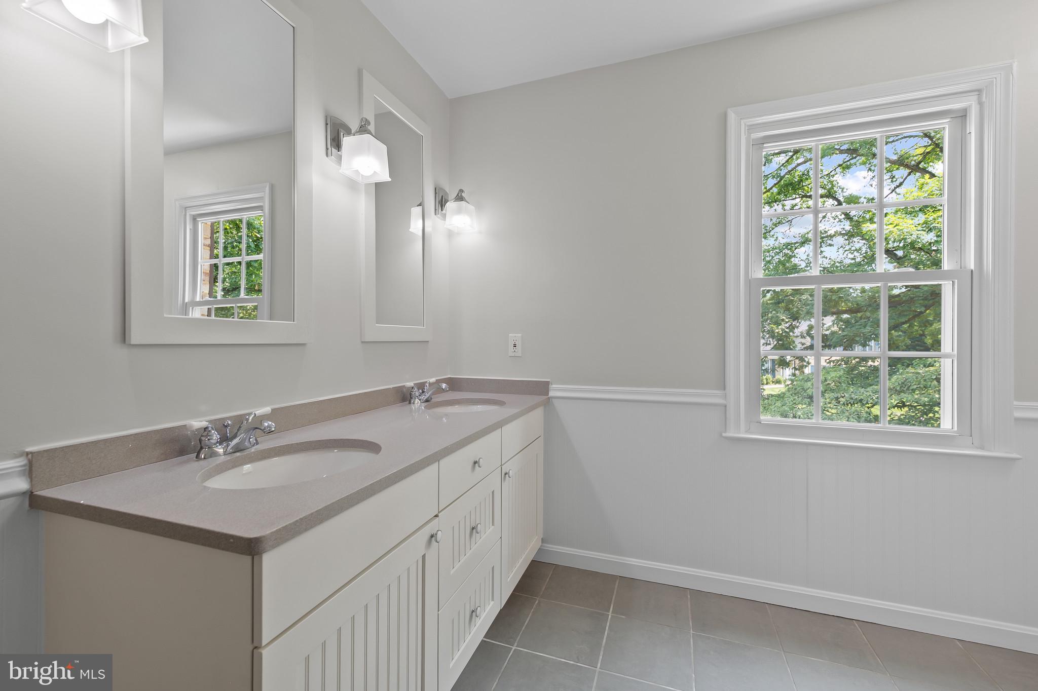 15016 Wellwood Road Silver Spring, MD 20905 - Photo 32 of 52 a bathroom with a sink double vanity and a mirror
