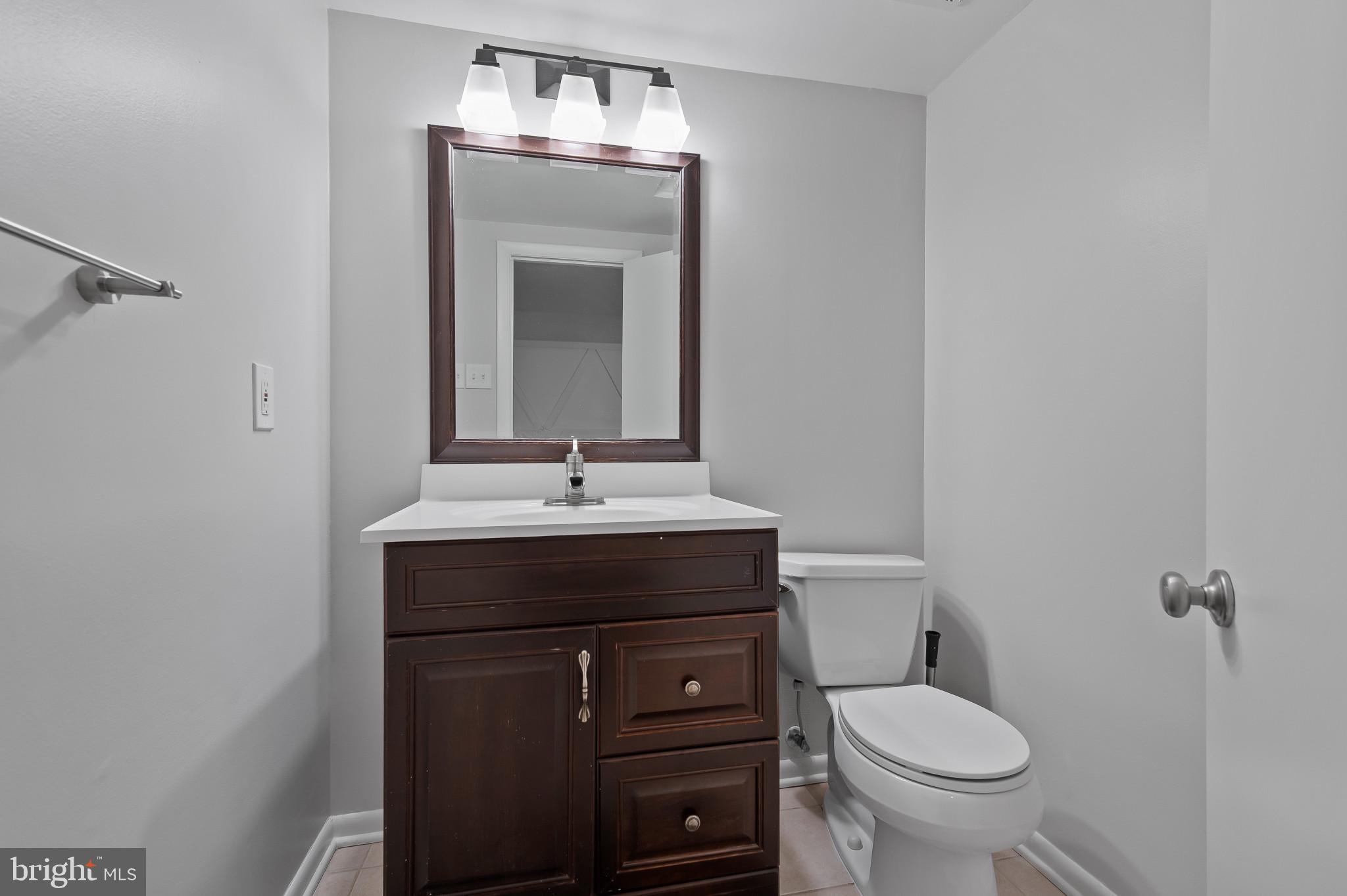 15016 Wellwood Road Silver Spring, MD 20905 - Photo 39 of 52 a bathroom with a sink toilet and mirror