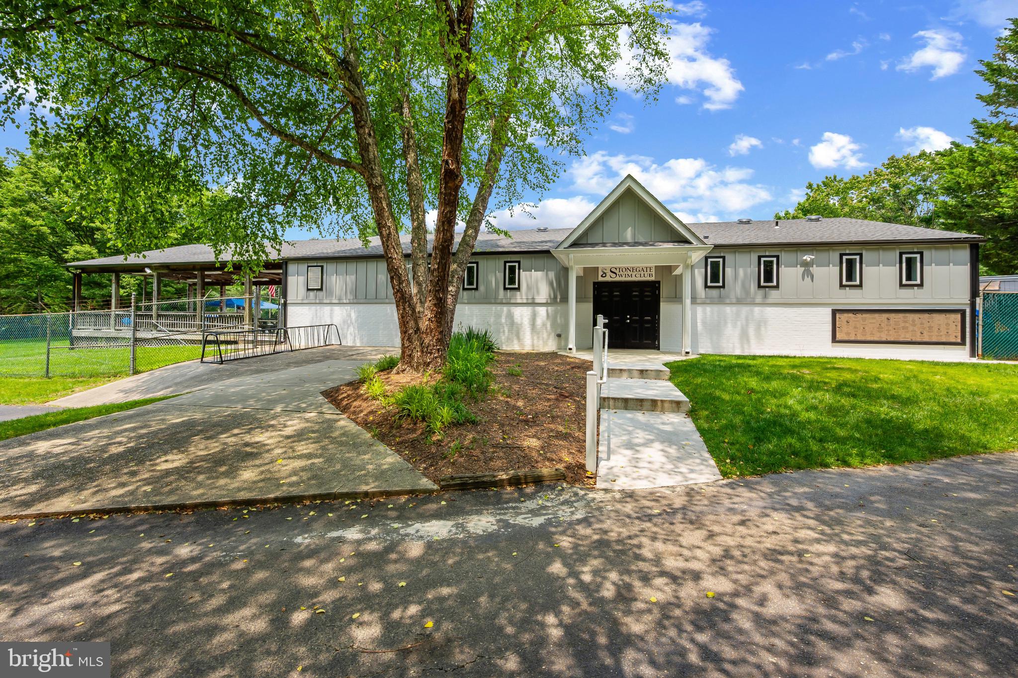 15016 Wellwood Road Silver Spring, MD 20905 - Photo 45 of 52 a front view of a house with yard and green space