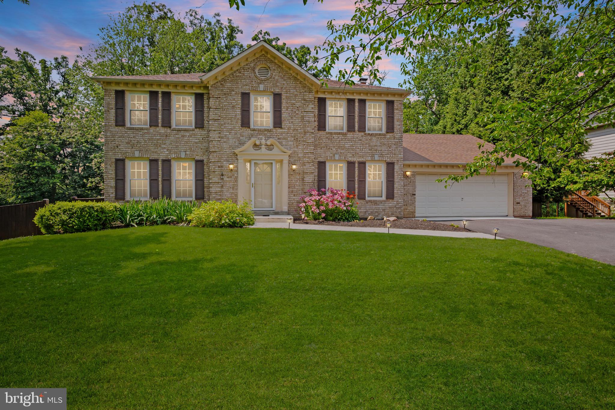 15016 Wellwood Road Silver Spring, MD 20905 - Photo 48 of 52 a front view of a house with a yard and trees