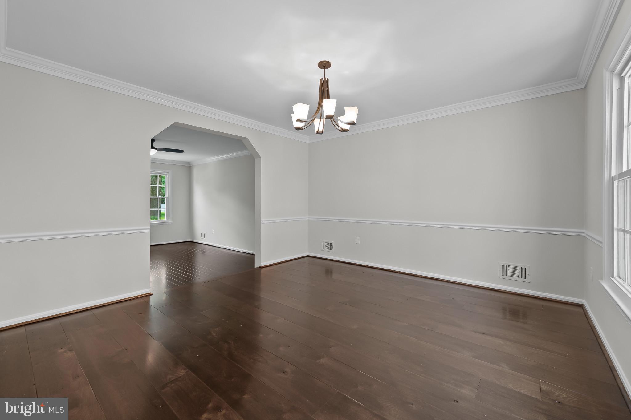 15016 Wellwood Road Silver Spring, MD 20905 - Photo 7 of 52 an empty room with wooden floor and windows