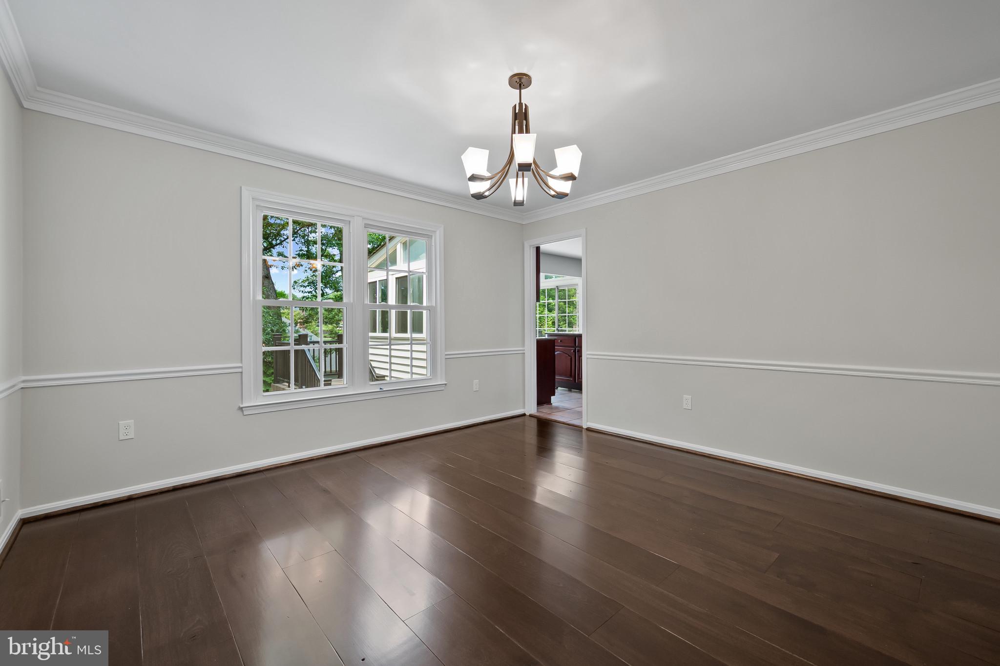 15016 Wellwood Road Silver Spring, MD 20905 - Photo 8 of 52 a view of an empty room with wooden floor and a window