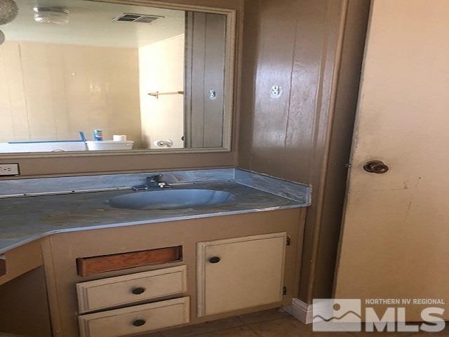 490 Capricorn Circle Reno, NV 89521 - Photo 17 of 26 a bathroom with a sink and a mirror