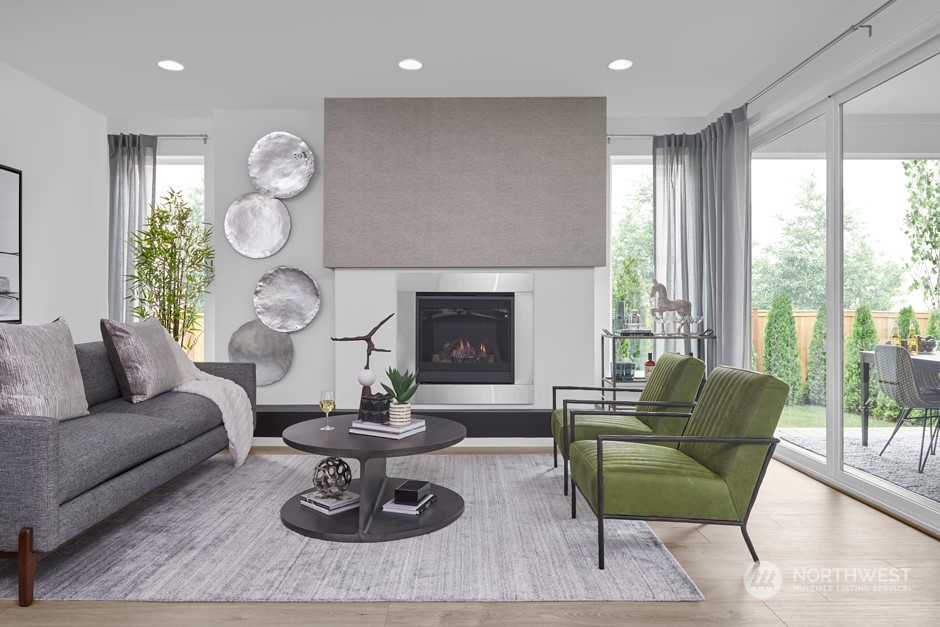 5661 Great Gln Road Southwest Port Orchard, WA 98367 - Photo 5 of 10 a living room with furniture a fireplace a large window and potted plant