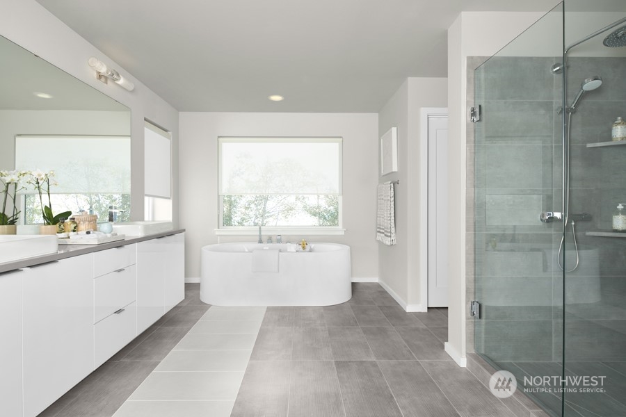 5661 Great Gln Road Southwest Port Orchard, WA 98367 - Photo 10 of 10 a large en suite bathroom with a granite countertop sink mirror and a bathtub