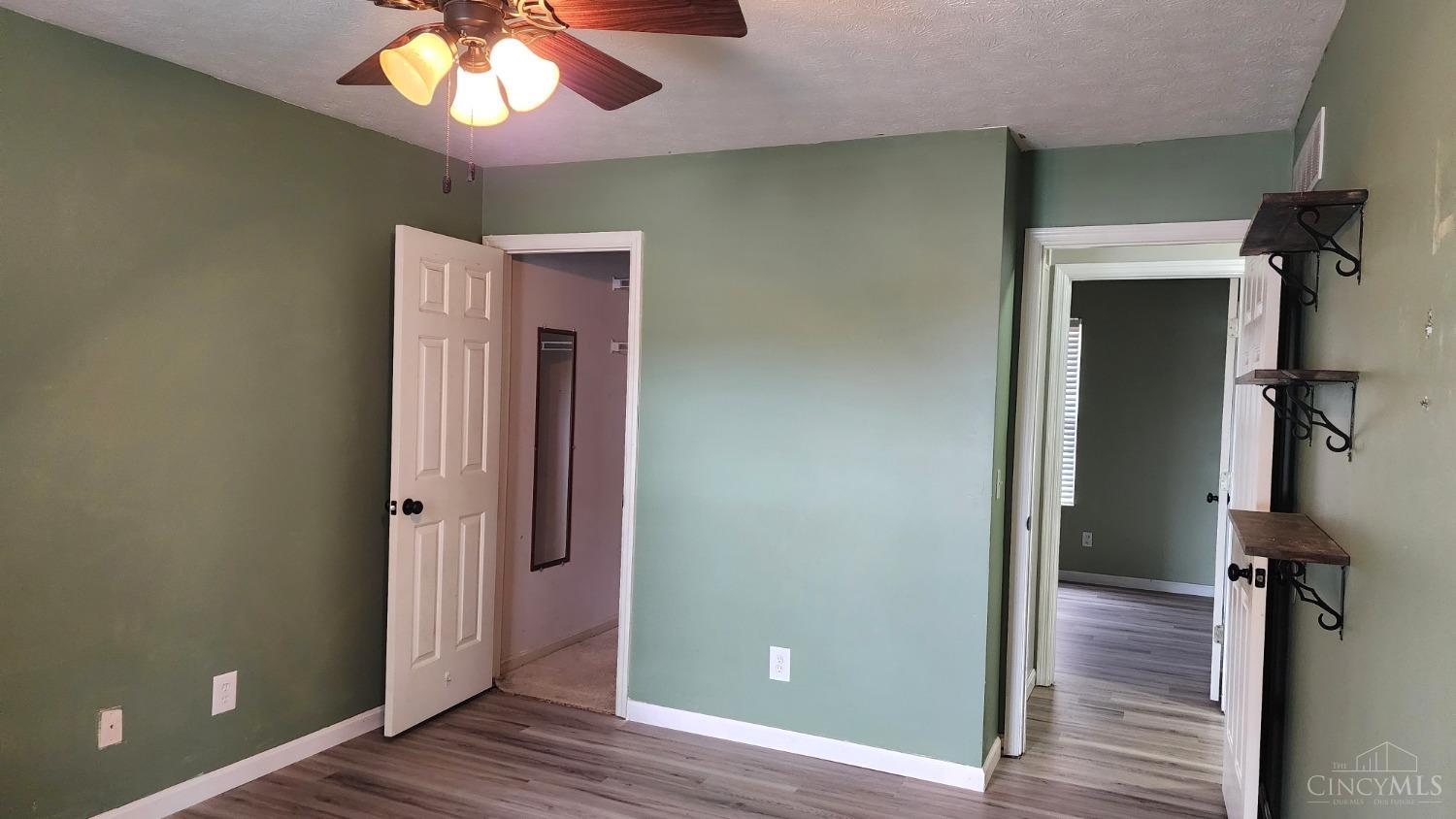 707 Hummingbird Way Maineville, OH 45039 - Photo 9 of 24 Primary bedroom features a walk in closer, newer ceiling fan and an updated full bathroom