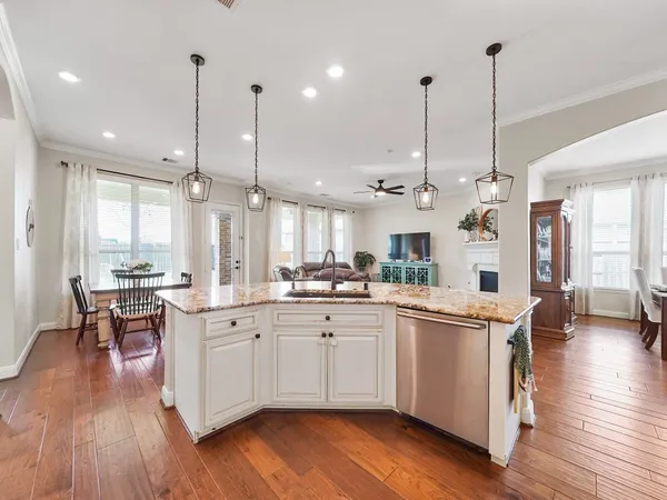 a kitchen with stainless steel appliances granite countertop wooden floors sink and cabinets