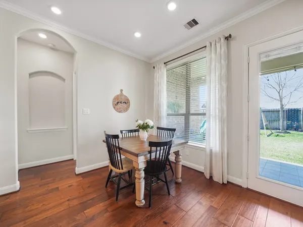 a view of a dining room with furniture and wooden floor