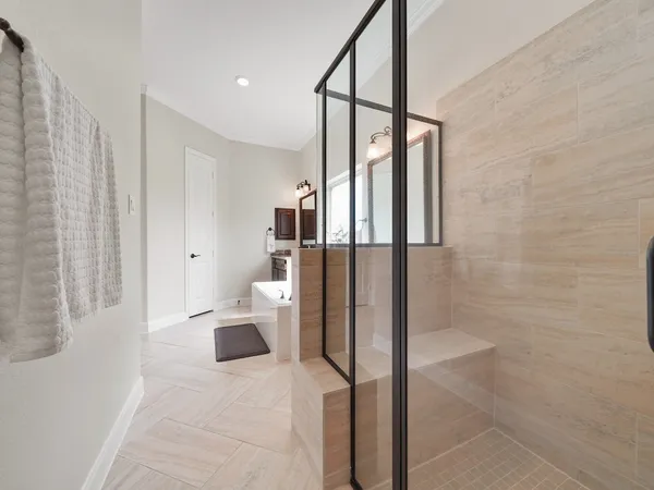 a bathroom with a glass shower door and a bathtub