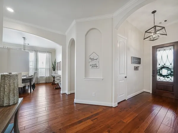 a view of a livingroom with wooden floor and furniture
