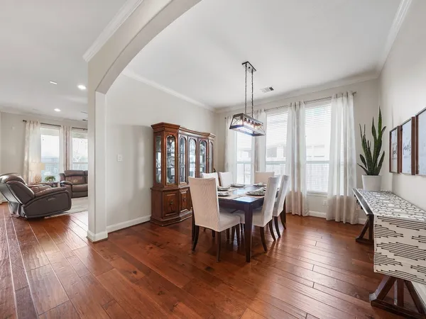 a view of a dining room with furniture window and wooden floor