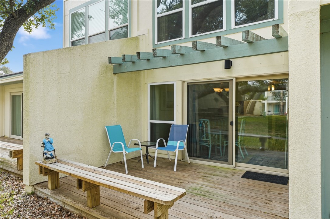 2003 North Fulton Beach Road, Unit 34 34 Rockport, TX 78382 - Photo 22 of 38 a balcony with table and chairs