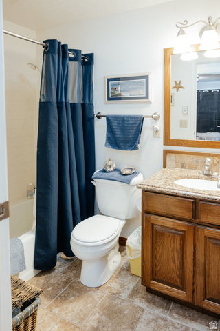 322 Bailey Creek Road Soda Springs, ID 83276 - Photo 11 of 32 Bathroom featuring a tub/shower combination, a vanity with a stone-finish countertop, and wood-finish cabinetry