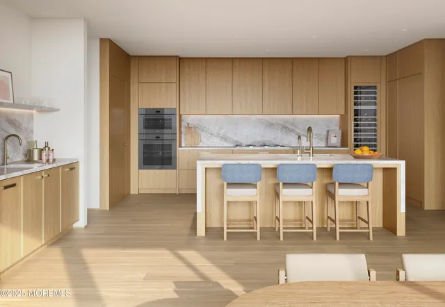 a kitchen with granite countertop a stove a sink and a refrigerator